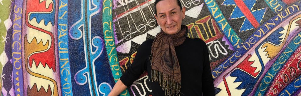 Photo of Garza against a bright colored background